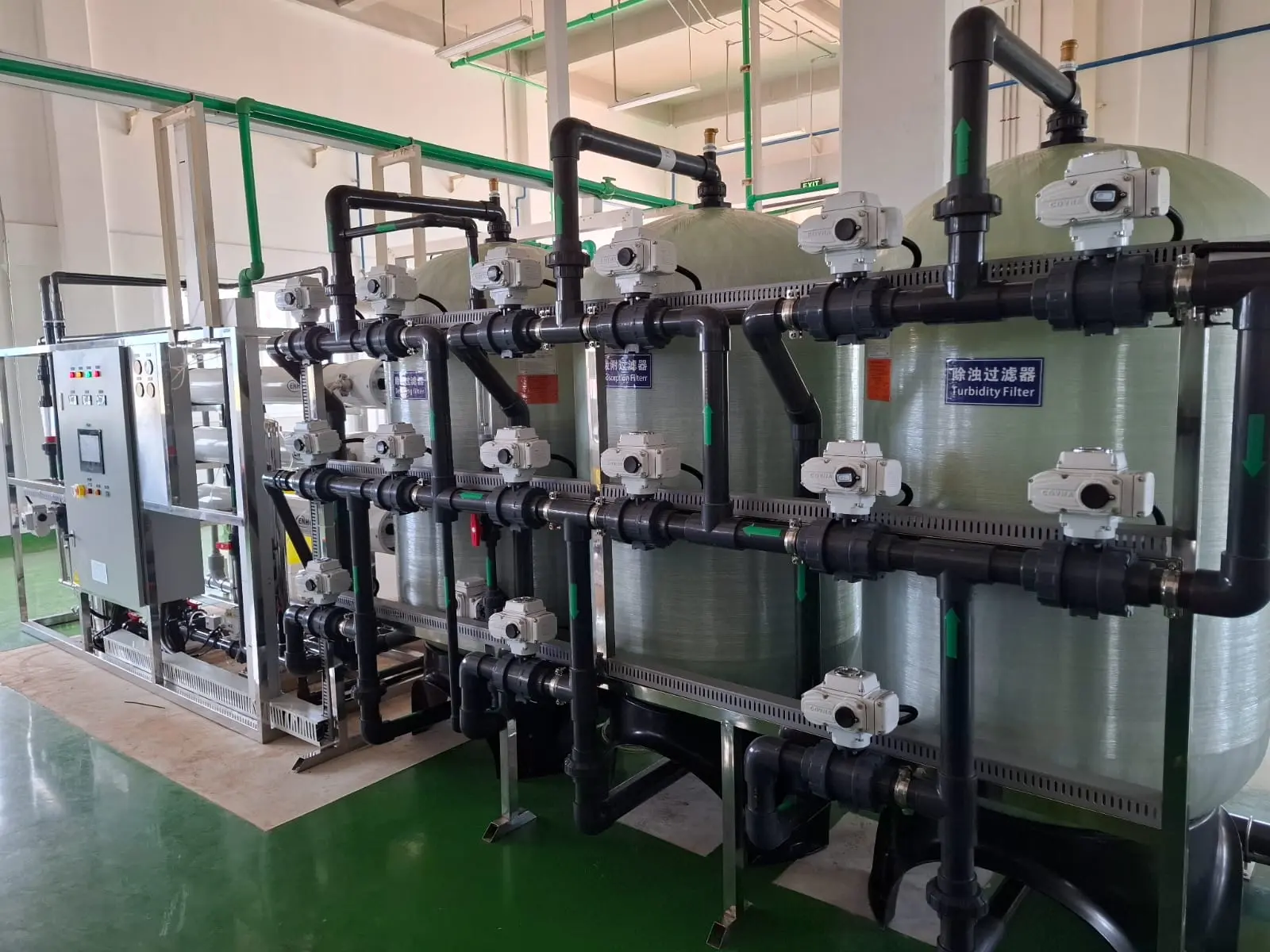 Project site — RO and pretreatment skids on the factory floor (wide view)